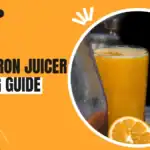 Cast Iron Juicer: The Complete Buying & Using Guide Cast iron juicer press with a lever handle, fresh orange and a glass of orange juice
