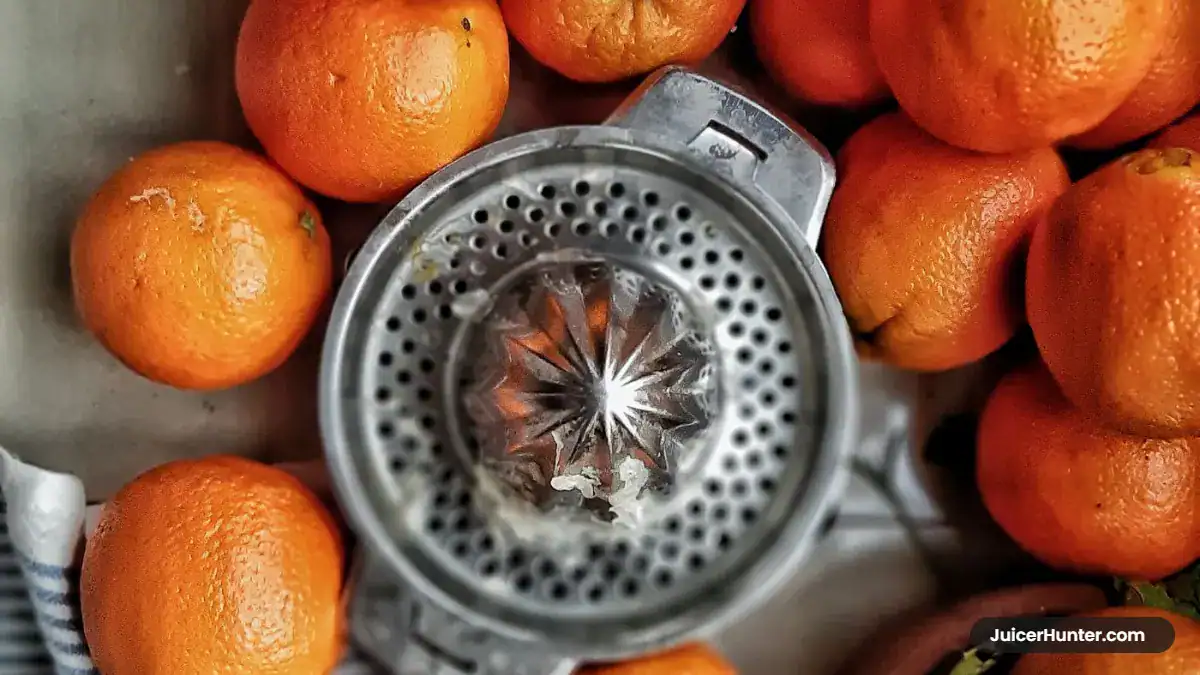 Cast iron juicer press compared with an electric citrus juicer