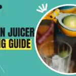 Yellow handheld lemon juicer with fresh lemons and a glass of lemon juice